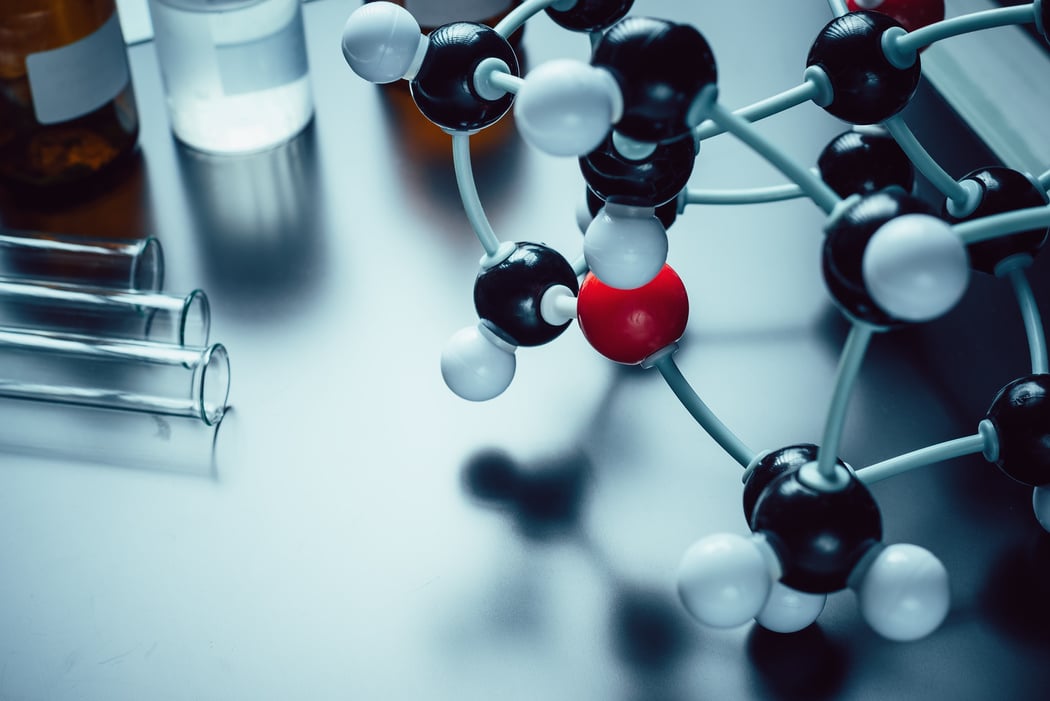 molecular formula and laboratory equipment on a blue background with copy space. Science organic chemistry concept